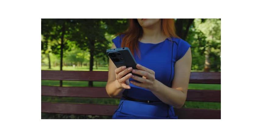 Closeup of Female Hands Text Messaging on Mobile Phone Outdoors