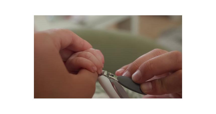 Gentle moment of a baby’s nails being trimmed. Perfect for parenting and childcare tutorials.