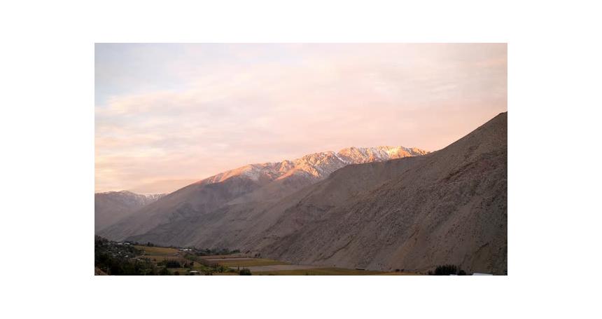 Timelapse of the mountains in Elqui Valley Chili from day to night with clouds and pink sky on a bea