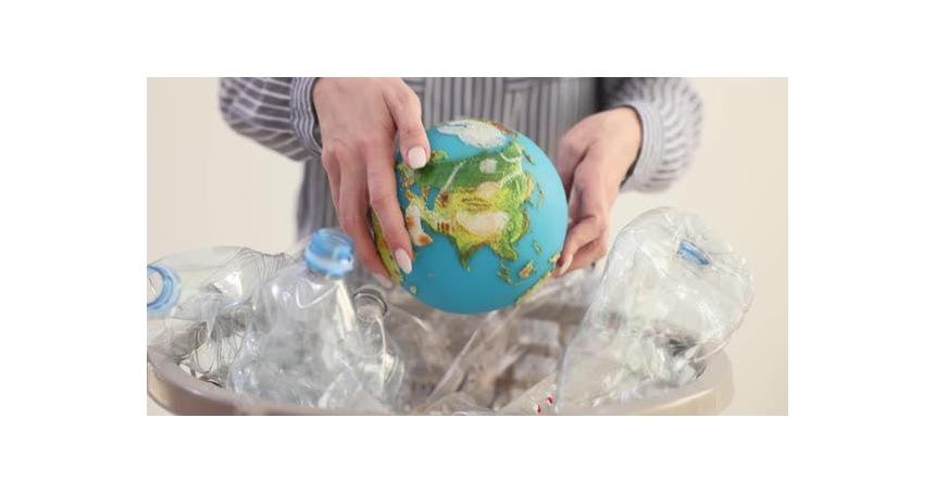 Woman Takes Globe Out of Basket Full of Plastic Bottles